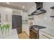 Stylish kitchen featuring marble countertops, black appliances, and white cabinetry at 15 Dewey St, Charleston, SC 29403