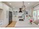 Well-lit kitchen with marble countertops, modern appliances, and ample storage at 15 Dewey St, Charleston, SC 29403