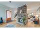 Open-concept living room with brick fireplace, hardwood floors, and lots of natural light at 15 Dewey St, Charleston, SC 29403