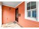 Charming porch with black front door, stone flooring, and salmon siding at 15 Dewey St, Charleston, SC 29403