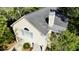Aerial view of a tan, well maintained two-story home with a gray roof and mature landscaping at 1551 Ben Sawyer Blvd # 23, Mount Pleasant, SC 29464