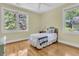 Cozy bedroom with natural light, hardwood floors, and a comfortable single bed at 1551 Ben Sawyer Blvd # 23, Mount Pleasant, SC 29464