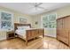 Comfortable bedroom with hardwood floors, large windows, and a rustic wood dresser at 1551 Ben Sawyer Blvd # 23, Mount Pleasant, SC 29464