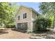 Exterior view of a yellow two-story home with ground level storage at 1551 Ben Sawyer Blvd # 23, Mount Pleasant, SC 29464
