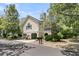 Inviting two-story home with beige siding, a chimney, and lush landscaping offers comfortable living and charm at 1551 Ben Sawyer Blvd # 23, Mount Pleasant, SC 29464