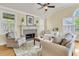 Comfortable living room features a fireplace, ceiling fan, and neutral-toned furnishings at 1551 Ben Sawyer Blvd # 23, Mount Pleasant, SC 29464