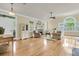 Bright living room features a brick fireplace, ceiling fan, and large windows with plantation shutters at 1551 Ben Sawyer Blvd # 23, Mount Pleasant, SC 29464