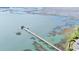 Aerial view of a long wooden pier extending into the calm waters, perfect for leisurely strolls and fishing at 1551 Ben Sawyer Blvd # 23, Mount Pleasant, SC 29464
