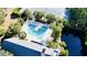 Aerial view of community pool area, featuring palm trees, lounge chairs, and clear blue water, perfect for relaxation at 1551 Ben Sawyer Blvd # 23, Mount Pleasant, SC 29464