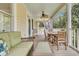 Charming screened porch with wicker furniture, ceiling fan, and ample seating for entertaining guests at 1551 Ben Sawyer Blvd # 23, Mount Pleasant, SC 29464