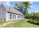 Rear exterior view of the house with a screened in porch and large yard at 1572 Pixley St, Charleston, SC 29414
