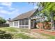 Back exterior featuring a screened-in porch, wooden pergola, and a charming swing set at 1572 Pixley St, Charleston, SC 29414