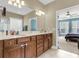 Open bathroom with double vanity, tile floor, and access to bedroom at 1572 Pixley St, Charleston, SC 29414