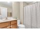 Well-lit bathroom featuring a vanity with solid surface countertop, and a shower with a striped curtain at 1572 Pixley St, Charleston, SC 29414