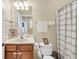 Bathroom featuring a vanity with sink, toilet, and shower with patterned curtain at 1572 Pixley St, Charleston, SC 29414