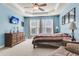 Bright bedroom with tray ceiling, triple windows, and hardwood furniture at 1572 Pixley St, Charleston, SC 29414