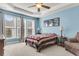 Inviting bedroom featuring tray ceiling, large windows, and blue walls at 1572 Pixley St, Charleston, SC 29414