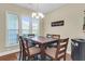 Bright dining area featuring wood table and chairs, decorative lighting, and natural light from the large windows at 1572 Pixley St, Charleston, SC 29414