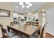 Dining area open to the kitchen featuring a dark wood table with seating for six and a modern chandelier at 1572 Pixley St, Charleston, SC 29414