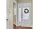 Light-filled entryway featuring hardwood floors and a view of the front door with glass panels at 1572 Pixley St, Charleston, SC 29414