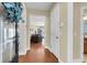 Entryway showcasing hardwood floors, views into the living room, and a coat closet at 1572 Pixley St, Charleston, SC 29414