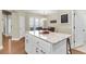 Kitchen island featuring white cabinetry, granite countertops, and a breakfast bar next to the dining area at 1572 Pixley St, Charleston, SC 29414