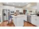 Bright kitchen features white cabinets, stainless appliances, granite countertops, and wood floors at 1572 Pixley St, Charleston, SC 29414