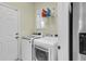 Functional laundry room featuring a washing machine, dryer, storage shelf, and convenient access to appliances at 1572 Pixley St, Charleston, SC 29414