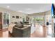 Spacious living room featuring a large sectional sofa, natural light, and hardwood floors at 1572 Pixley St, Charleston, SC 29414