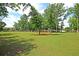Large grassy field in a park setting with scattered trees and walking path at 1572 Pixley St, Charleston, SC 29414
