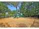 Community playground area featuring play equipment, a mulch ground cover, and shade trees at 1572 Pixley St, Charleston, SC 29414