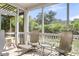 Cozy screened-in porch with seating, offering a relaxing outdoor space with views of the surrounding greenery at 1572 Pixley St, Charleston, SC 29414