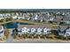 Gorgeous aerial view of a neighborhood with townhomes, a pond, and lush greenery, offering serene waterfront living at 1614 Prince Edward St, Mount Pleasant, SC 29466
