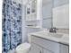 Well-lit bathroom with sink, toilet, shower/tub combo, and storage at 1614 Prince Edward St, Mount Pleasant, SC 29466