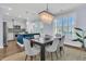 Bright dining area with stylish lighting, hardwood floors, and an open layout to the modern kitchen at 1614 Prince Edward St, Mount Pleasant, SC 29466