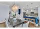 Stylish dining area featuring a modern chandelier, hardwood floors, and an open layout to the living room and kitchen at 1614 Prince Edward St, Mount Pleasant, SC 29466