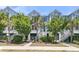 Charming townhome showcases a welcoming entryway with lush landscaping, adding to its curb appeal at 1614 Prince Edward St, Mount Pleasant, SC 29466