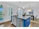Kitchen island with sink, stainless steel dishwasher, and seating overlooking a dining room at 1614 Prince Edward St, Mount Pleasant, SC 29466