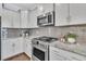 Modern kitchen features stainless steel appliances, gray subway tile backsplash, and granite countertops at 1614 Prince Edward St, Mount Pleasant, SC 29466