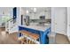 Open kitchen with a blue island with seating, stainless steel appliances, and stone countertops at 1614 Prince Edward St, Mount Pleasant, SC 29466