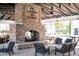 Outdoor community area with a large stone fireplace, comfortable seating, and picnic tables at 1614 Prince Edward St, Mount Pleasant, SC 29466