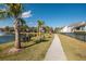 Landscaped walking path with palm trees beside a serene pond within a friendly community at 1614 Prince Edward St, Mount Pleasant, SC 29466