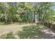 Large, grassy backyard with a wooden fence, offering privacy and space for outdoor activities at 1705 Sulgrave Rd, Charleston, SC 29414