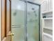 Bathroom shower with glass doors, white cabinets and showerhead, ideal for a quick rinse at 1705 Sulgrave Rd, Charleston, SC 29414
