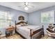 Cozy bedroom featuring light blue walls, wood flooring, and windows providing lots of natural light at 1705 Sulgrave Rd, Charleston, SC 29414