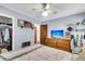 Comfortable bedroom featuring blue walls, ceiling fan, wood floors and dresser with television at 1705 Sulgrave Rd, Charleston, SC 29414