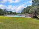 Community pool area with lounge chairs and a fenced perimeter, perfect for summer relaxation at 1705 Sulgrave Rd, Charleston, SC 29414