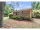 Brick house exterior with well-maintained landscaping and a quaint fenced perimeter at 1705 Sulgrave Rd, Charleston, SC 29414