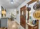 Charming foyer with wood flooring, decorative table, mirror, and view into dining area at 1705 Sulgrave Rd, Charleston, SC 29414