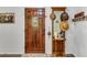 Warm foyer with wood door, decorative table, mirror, and welcome decor at 1705 Sulgrave Rd, Charleston, SC 29414